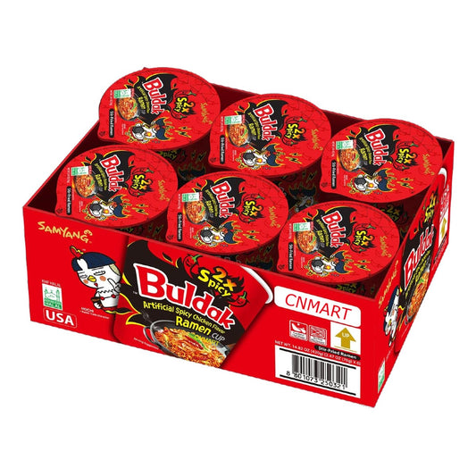 Samyang Buldak 2x Spicy Hot Chicken Flavour Ramen Cup multipack with six Korean instant noodle cups in branded red retail tray packaging, featuring extra spicy hot chicken flavour ramyun cups popular for Korean food trends, spicy noodle challenges, gaming snacks, student meals, and quick convenience food in the UK.