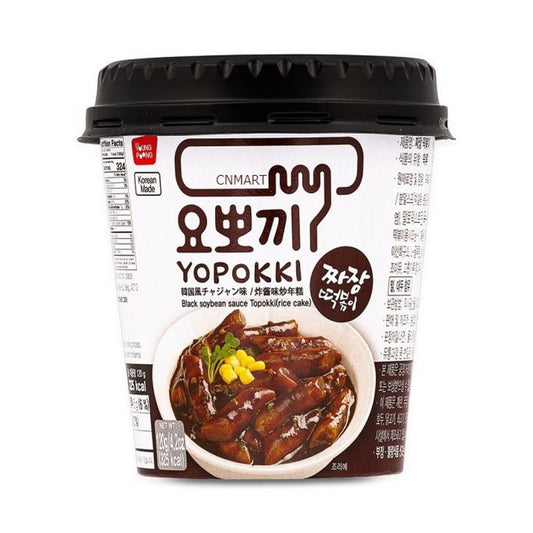 Yopokki Jjajang Topokki 120g instant cup with black lid, showing Korean and English product name and an image of rice cakes in black soybean sauce on the front label.